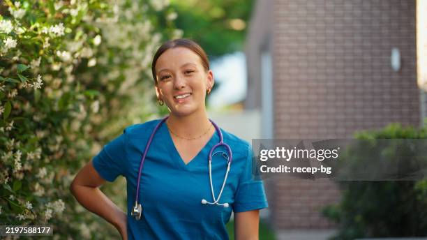 portrait of a nurse with stethoscope in garden setting - kindness stock pictures, royalty-free photos & images