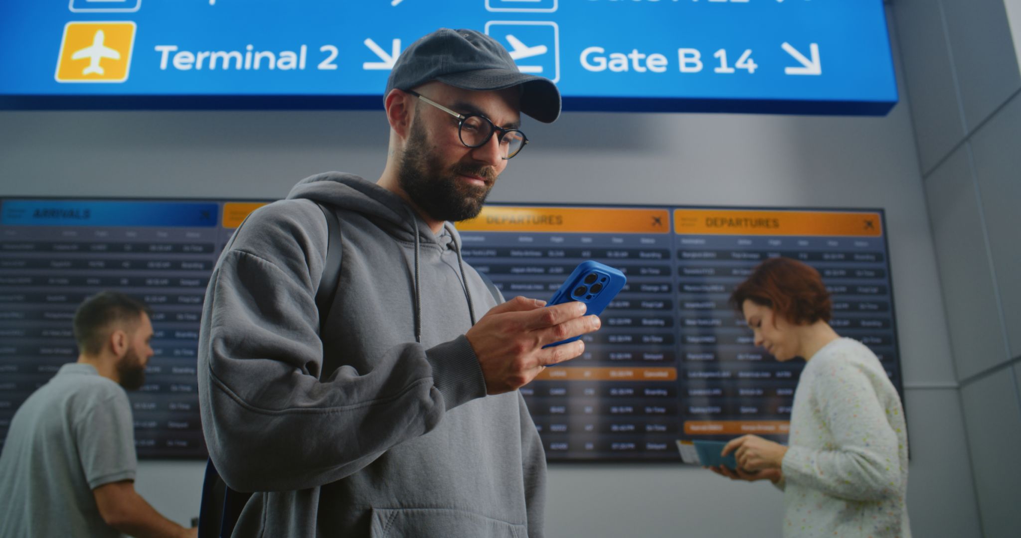 Airport Terminal: Tourist with Backpack Checks His Flight Scanning Ticket Using Phone Airport Terminal: Tourist with Backpack Checks His Flight Scanning Ticket Using Phone