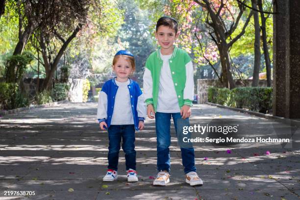 two young boys, jewish brothers using yarmulkes, pose for the camera - mexico city, mexico - blue skullcap stock pictures, royalty-free photos & images