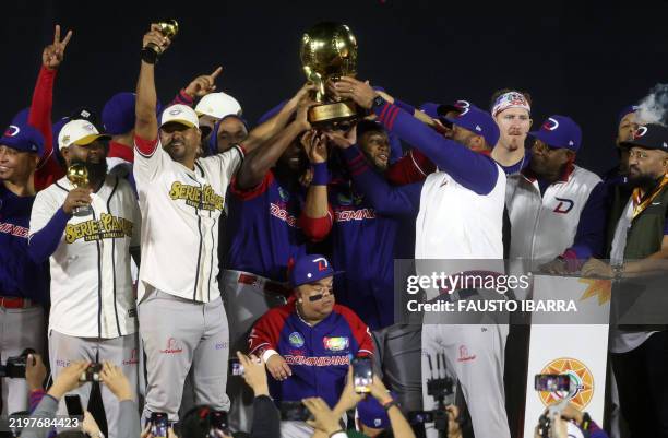 Players from Dominican Republic's Leones del Escogido hold the trophy after their victory over Mexico's Charros de Jalisco in the Caribbean Series...
