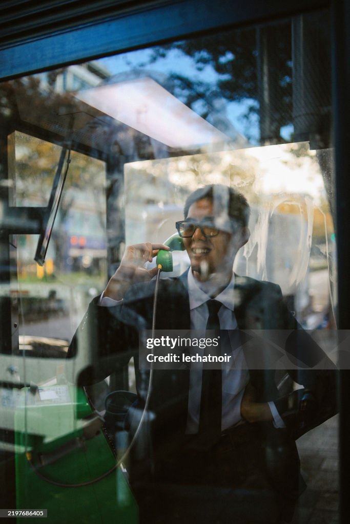 Man talking on the payphone in Tokyo