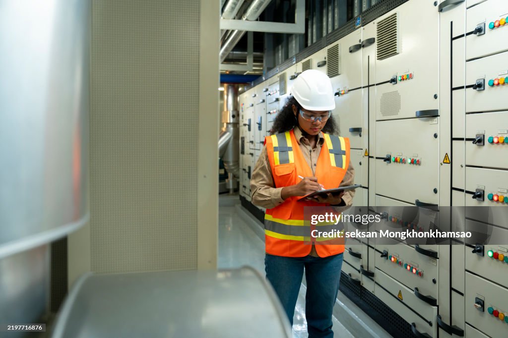 Electrical engineer in switchgear control room to check fault management and power outages.