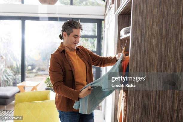 Man Intensely Sorting 720 Man Organizing Closet Stock Photos, High-Res Pictures, and Images ...