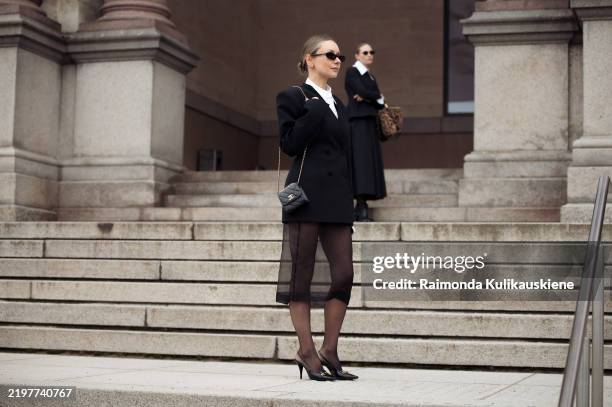 Justyna Czerniak wears black tule skirt, white shirt, black jacket, black tights and blakc Chanel mini bag outside the MKDT fashion show during the...