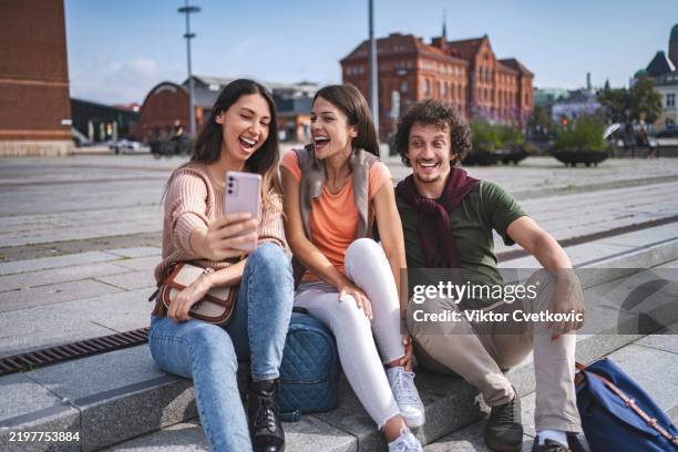 group of young adults taking a selfie in malmo, sweden - city break stock pictures, royalty-free photos & images