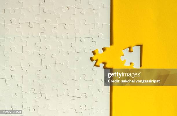 a final jigsaw puzzle piece into a last blank, 1q test, successful problem solving concept - work in progress concept stock pictures, royalty-free photos & images