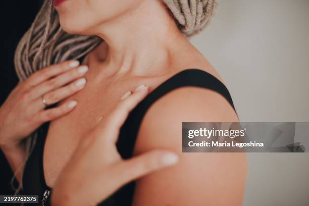 close-up from the side of the neck, shoulder and decollete area, indicating possible pain in this area , a woman 30-37 in a black bra, holding her hands by the straps, a frame without a face. - off shoulder stock pictures, royalty-free photos & images