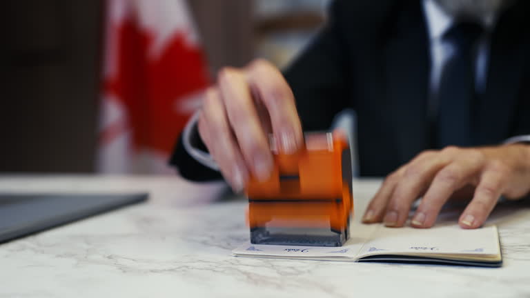 https://media.gettyimages.com/id/2197803857/video/canadian-embassy-officer-stamps-approved-in-a-passport-confirming-the-entry.jpg?b=1&s=640x640&k=20&c=UxP-q4Pl7tgRBhASF_S69PMgZMUGOFzGlDaPf99RtEY=