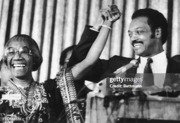 Democratic presidential candidate Jesse Jackson raises the arm of former Rep. Shirley Chisholm, NY, as he addresses a meeting of the Black women's...