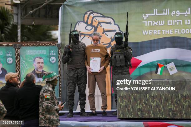 Hamas militants prepare to hand over the hostages to Red Cross officials in Gaza, Gaza Strip, on February 8, 2025. Hamas hands over three Israeli...