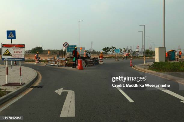 Workers are seen at the construction site at the Port City Colombo, the Chinese owned financial hub on the reclaimed land of the sea of Colombo on...