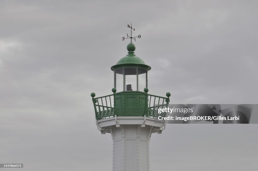Saint quay Portrieux, A green and white lighthouse stands against a cloudy sky