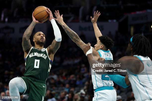 Damian Lillard of the Milwaukee Bucks attempts a jump shot during the second half of the game against the Charlotte Hornets at Spectrum Center on...