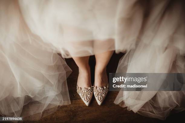 bride in wedding dress and beaded jewel high heals - woman putting on diamond stock pictures, royalty-free photos & images