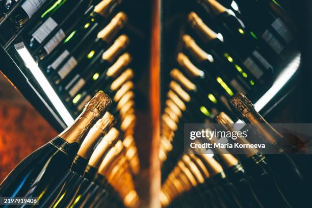 wine bottles on shelf at a winery. - champanhe imagens e fotografias de stock
