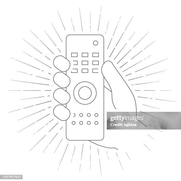 hand holding remote control. line icon with sunbursts on white background - holding remote control stock illustrations