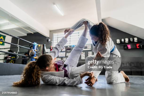 females training jiu-jitsu at the gym - jujitsu stock pictures, royalty-free photos & images