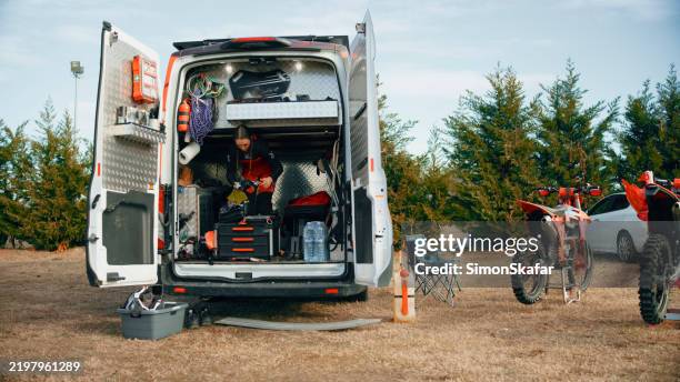 female motocross rider prepares at pit stop - off road racing stock pictures, royalty-free photos & images