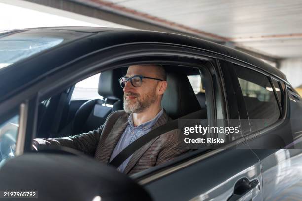 a mature man focusing on driving - parking stock pictures, royalty-free photos & images