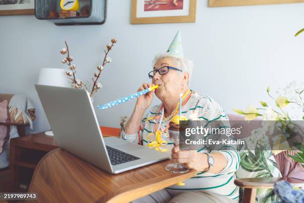 senior woman at home - wind instrument stock pictures, royalty-free photos & images