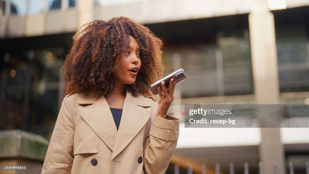 Fashionable Young Businesswoman Using an AI App on Smartphone