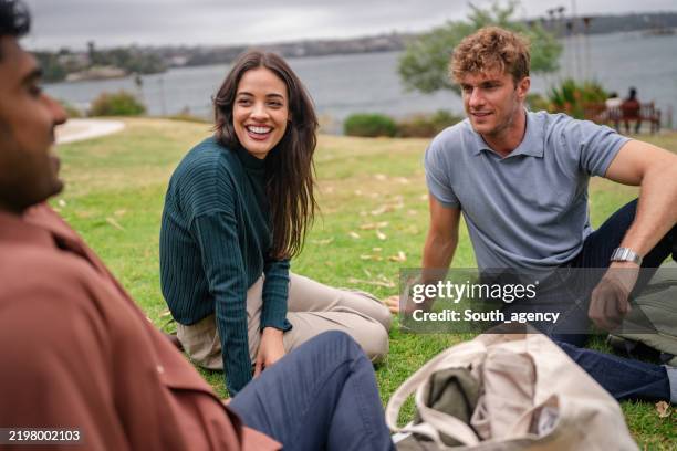joyful young adults enjoying a sunny weekend afternoon together in sydney, australia near the waterfront - friends picnic stock pictures, royalty-free photos & images