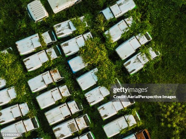 top view of rows of abandoned trucks - scrap yard scale stock pictures, royalty-free photos & images
