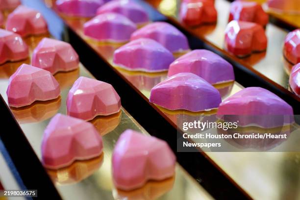 Some of the various shapes, designs and flavors of chocolate hearts and lips for Valentines Day on display at the Cacao and Cardamom shop, where they...
