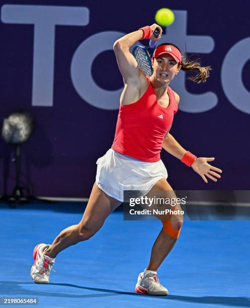 Elina Avanesyan of Armenia competes in her first-round match against Xinyu Wang of China during the WTA Qatar TotalEnergies Open 2025 tennis...