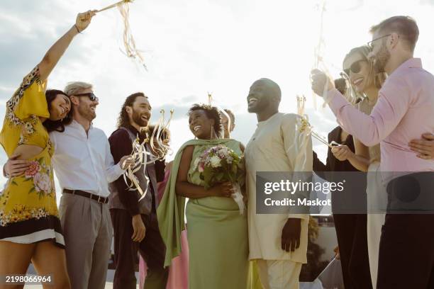 happy friends standing with newly married couple at wedding reception - arab bride stock pictures, royalty-free photos & images