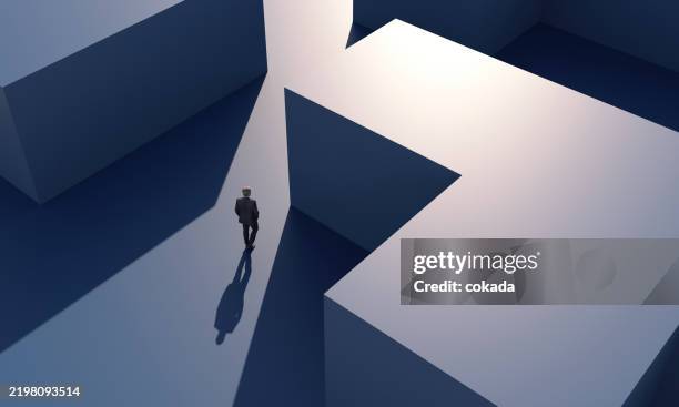 businessman walking at modern building - maze stock pictures, royalty-free photos & images