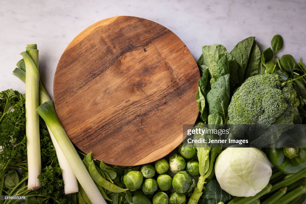 Fresh green vegetables on a marble background.