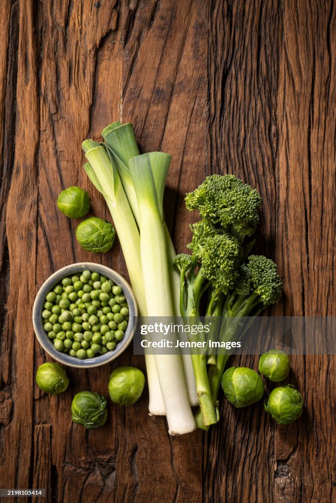 Fresh green vegetables on a dark wood background. Super food concept.