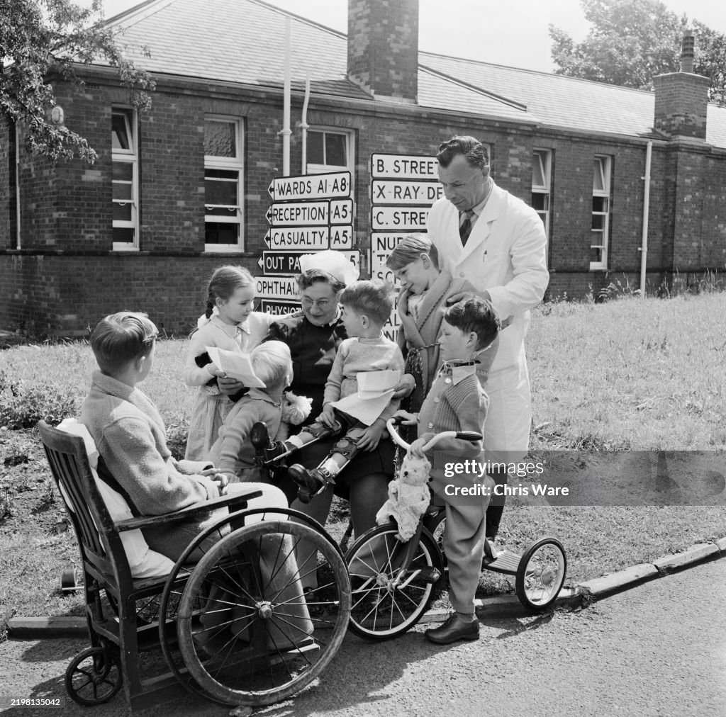 Matron A matron is surrounded by young patients as she reads letters from ...