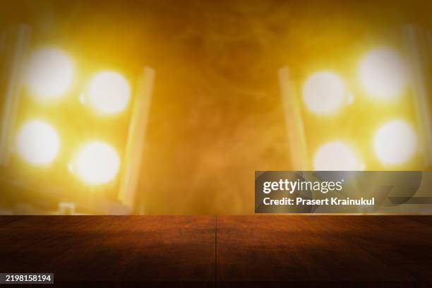 empty wood table with concert spotlight - empty concert stock pictures, royalty-free photos & images