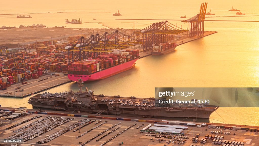 Aerial view nuclear ship, Military navy ship carrier full loading fighter jet aircraft and helicopter at port.