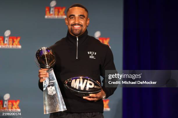 Quarterback Jalen Hurts of the Philadelphia Eagles, the MVP of Super Bowl LIX, holds both the MVP and Vince Lombardi trophies during a press...