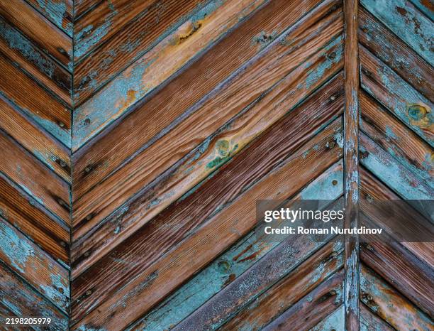 A pattern of painted wood beams on the old facade of a house