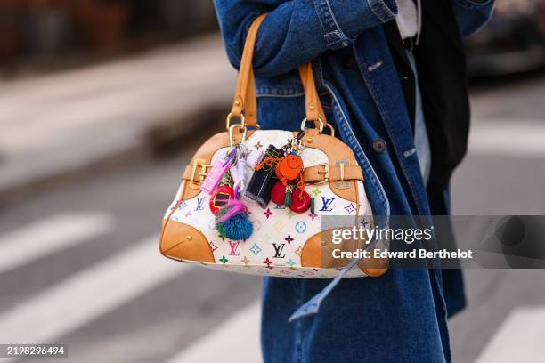 Guest wears a white Louis Vuitton multicolor monogram Louis Vuitton Claudia Vintage canvas bag, bag charms, outside Theory, during the New York...