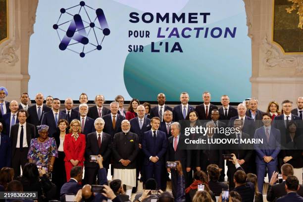 France's President Emmanuel Macron poses for a group picture with world leaders and attendees at the end of the plenary session of the Artificial...