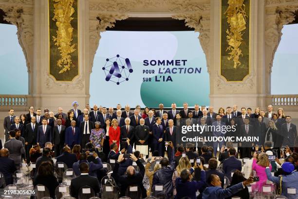 France's President Emmanuel Macron poses for a group picture with world leaders and attendees at the end of the plenary session of the Artificial...