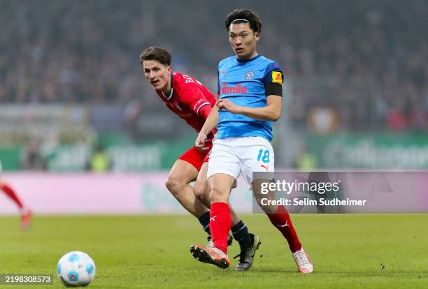 Shuto Machinoof Kiel fights for the ball with Tim Oermannof Bochum during the Bundesliga match between Holstein Kiel and VfL Bochum 1848 at...