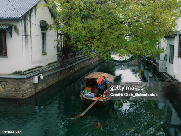 boat on canal in suzhou, china in autumn - suzhou tower stock pictures, royalty-free photos & images