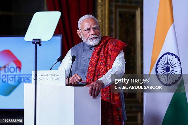 Indian Prime Minister Narendra Modi listens to French President's speech during the closing session of the Franco-Indian Economic Forum at the Quai...