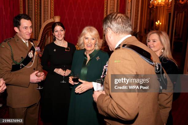Queen Camilla speaks to guests as she hosts a reception with representatives from her military affiliations to thank them for their service at...