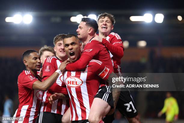 Exeter City's Northern Irish striker Josh Magennis celebrates after scoring his team first goal during the English FA Cup fourth round football match...