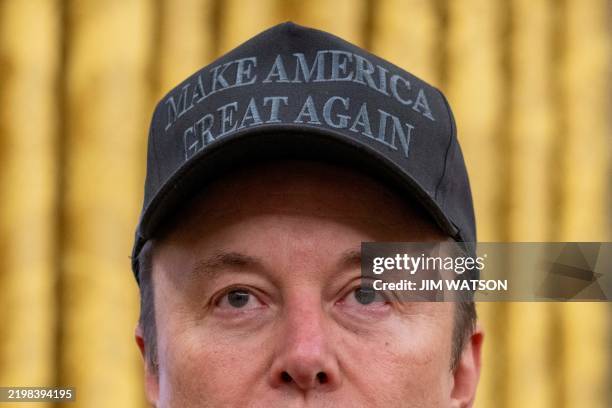 Tesla and SpaceX CEO Elon Musk looks on before US President Donald Trump signs executive orders in the Oval Office of the White House in Washington,...