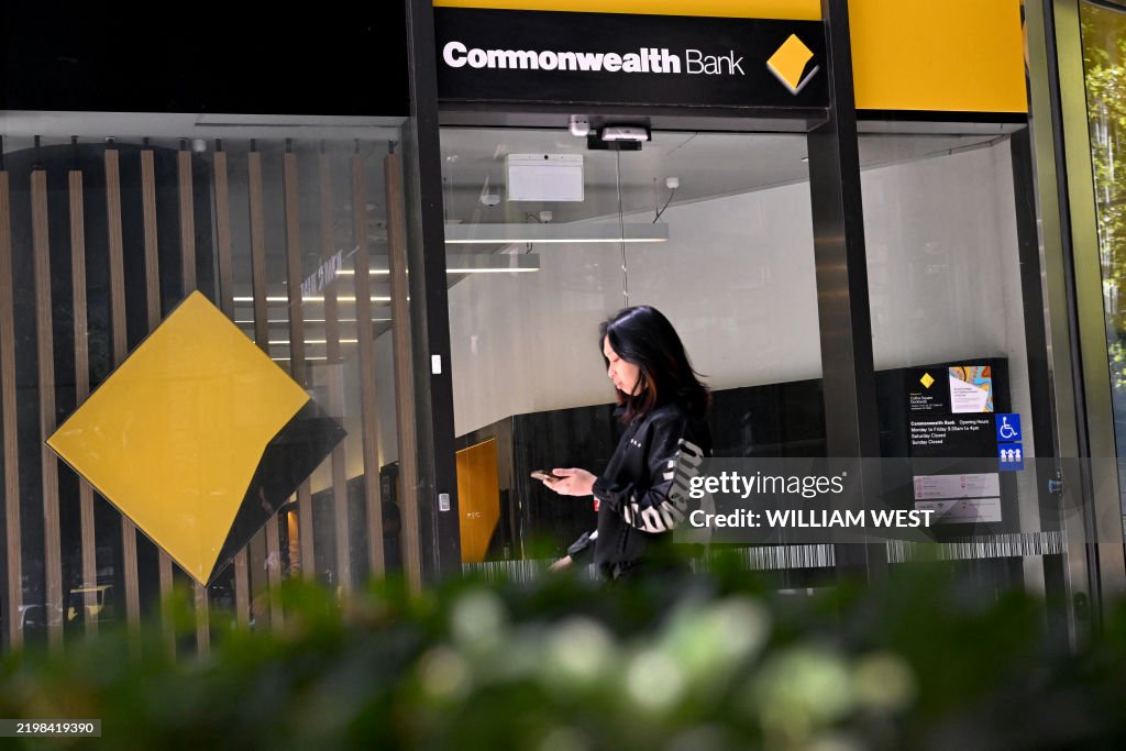 Maneli Rafat A person passes a branch of the Commonwealth Bank of Australia in ...
