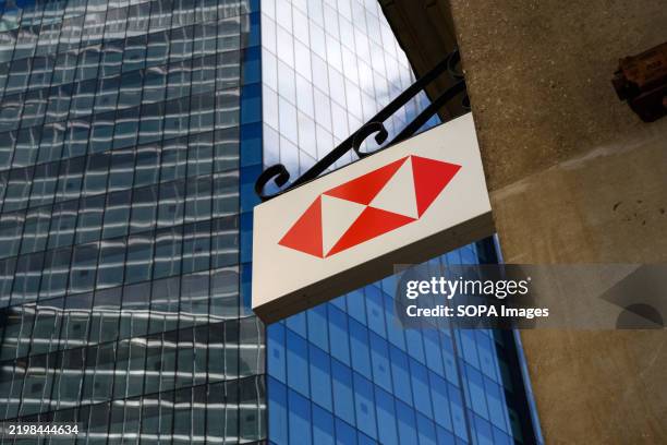 The logo of HSBC Holdings PLC, a British universal bank and financial services group seen at its headquarters.