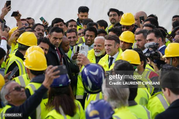 French President Emmanuel Macron and Indian Prime Minister Narendra Modi pose for selfies as they meet with workers during a visit at the ITER in...